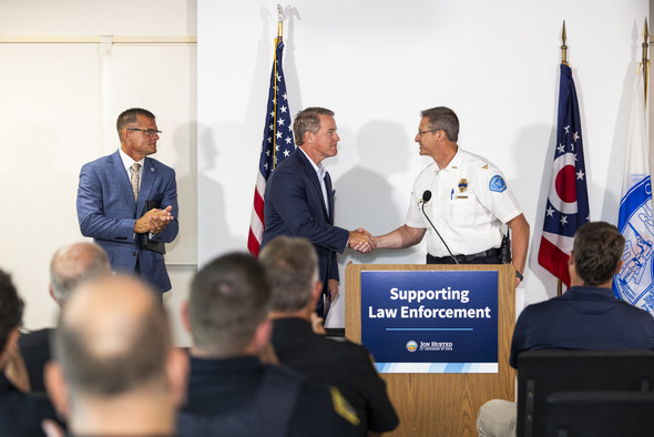 Husted shaking hands with officer