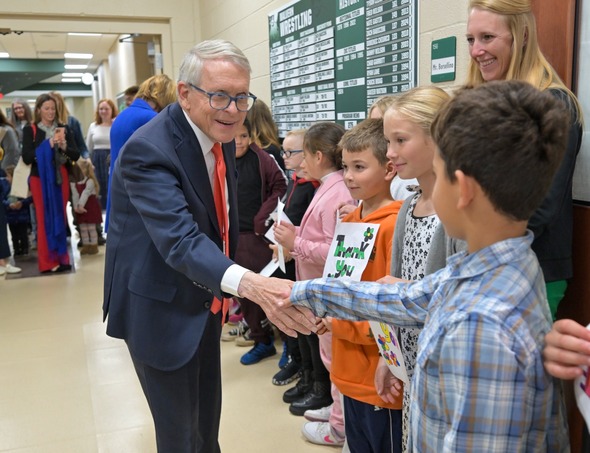 Governor DeWine shaking hands with a student.