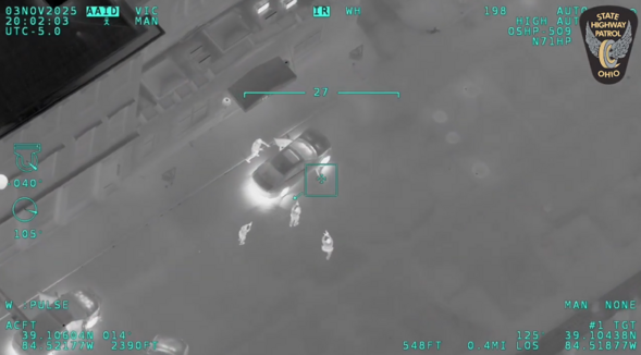 Night vision screenshot of law enforcement surrounding vehicle
