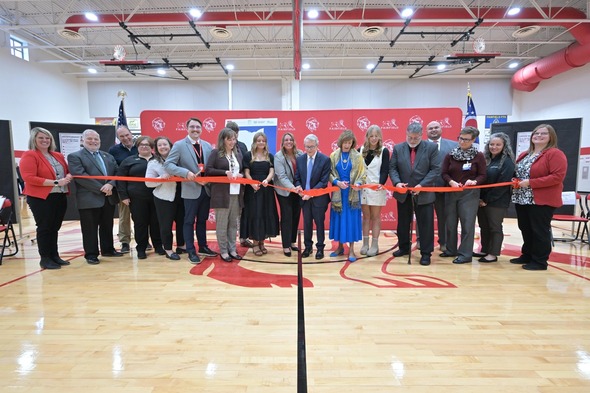 Governor and First Lady DeWine helping to cut the ribbon for the new Highland Health Partners Leesburg Family Medicine school-based health clinic.
