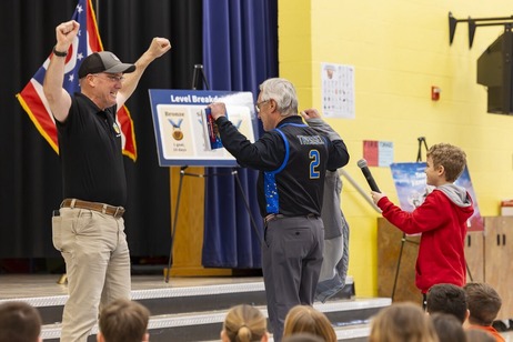 Maysville Elementary student holding microphone for Lt. Governor Tressel 