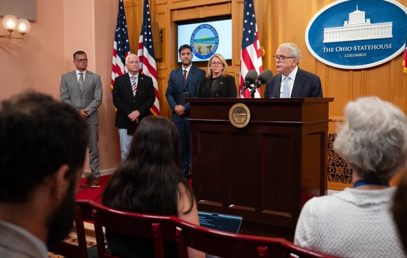 Governor DeWine stands behind podium at Recovery Housing press conference. 