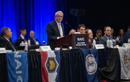 Governor DeWine speaking at a podium for the 2026 National Association of Insurance Commissioners (NAIC) Summer National Meeting. 