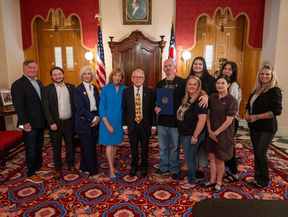 Governor and First Lady stand with group
