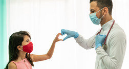 doctor and patient making a heart with their hands