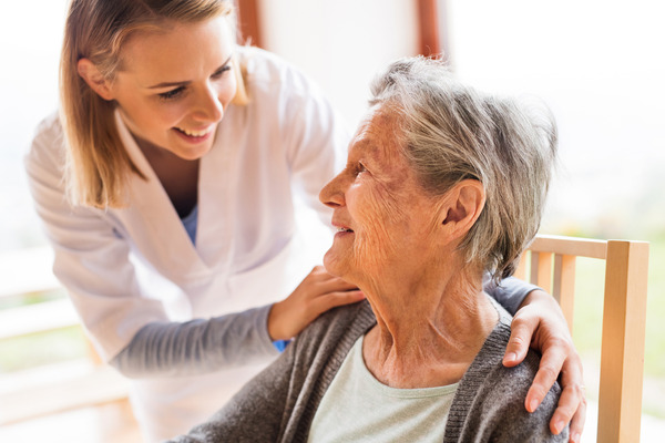 home health aide helping patient