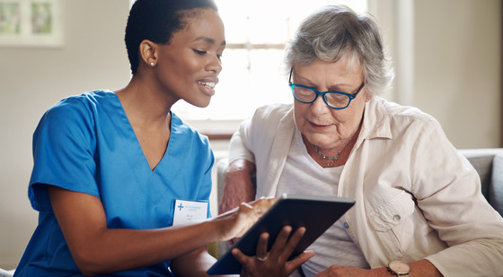 home health nurse working with patient