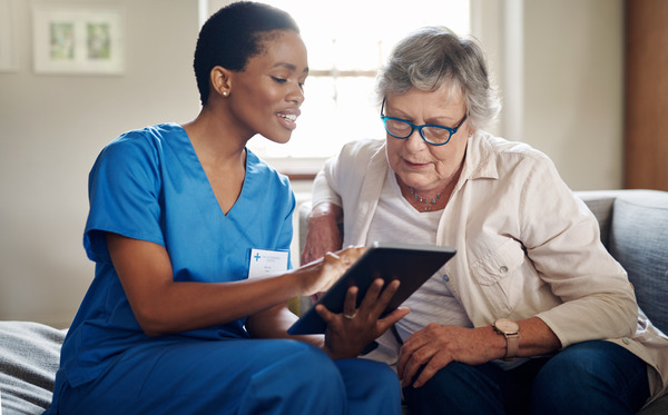 Nurse showing a patient their tablet