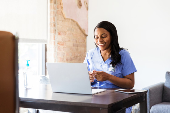 nurse using their laptop to submit information