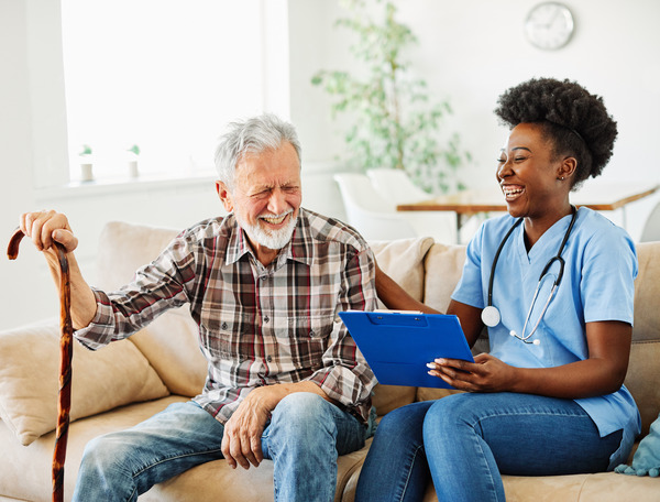 home health nurse and patient laughing together