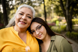 Mother and daughter smiling at camera