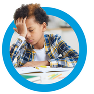 Child with head in hands over homework looks very stressed