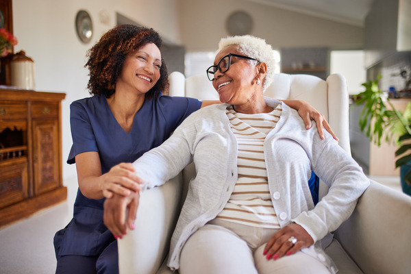 Nurse providing care for a woman at home
