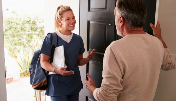 a homecare worker assists a man at his home