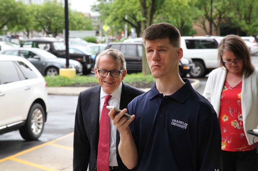 Governor Mike DeWine and blind student walking on Franklin University's Campus