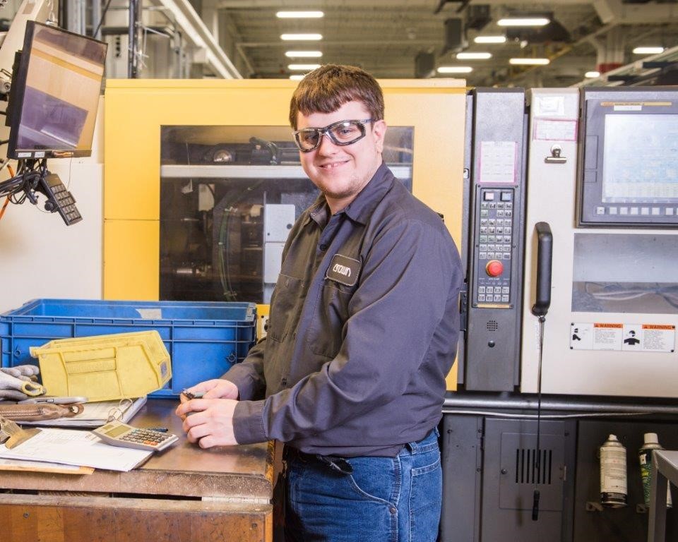 Photo of Zac Anderson at his work station at Crown Equipment Corporation