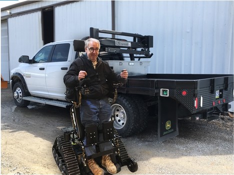 Don Hazelton using his action track chair in front of his truck
