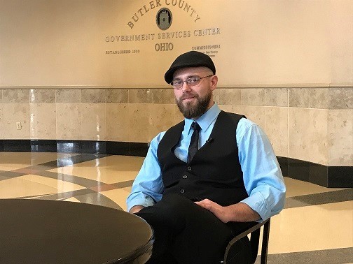  Young man with hat sitting at a table
