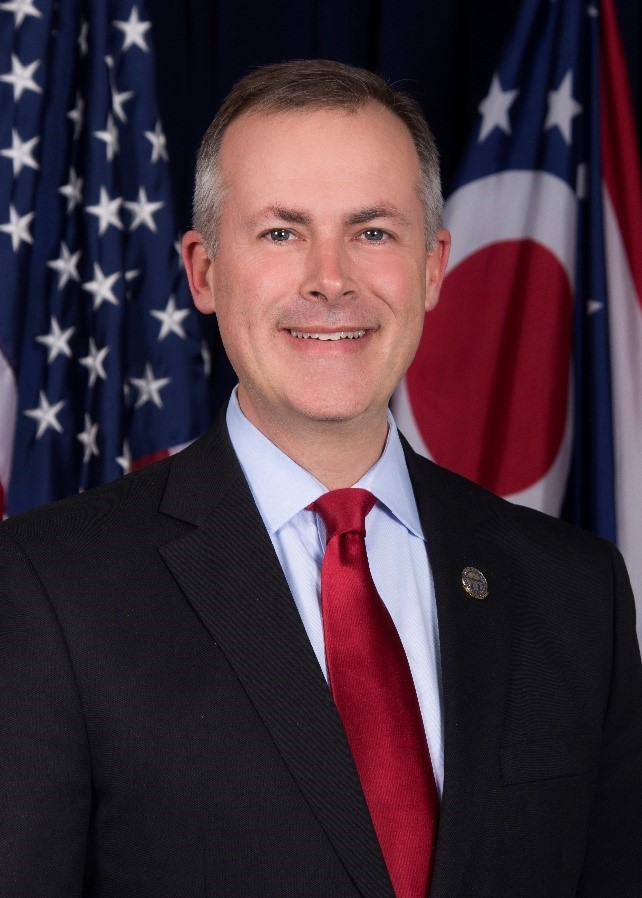 photo of  State Treasurer of Ohio Robert Sprague with flag in background