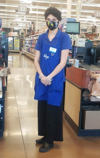  Photo of young woman who works at Kroger in front of her register