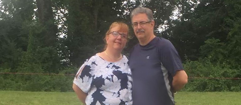  Photo of John Eneix and his wife with trees in the background