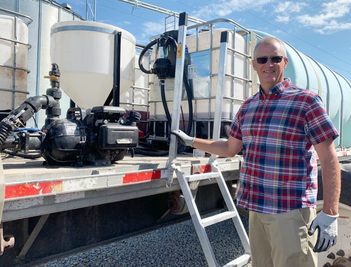 Photo of Doug Swaim in front of his flat bed truck