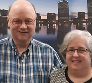 Photo of Ed and Marcia Miller in front of a body of water