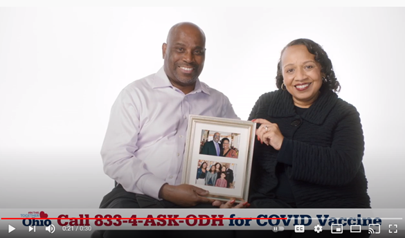Man and woman sitting, smiling, holding a family picture, call 833-4-ASK-ODH for COVID Vaccine
