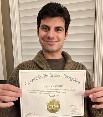  Photo of gentleman holding a recognition certificate