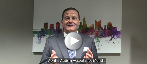 Photo of Director Miller with super imposed play button