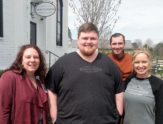 Photo of two men with two females smiling