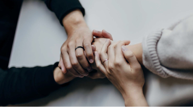 Photo of two people's hands intertwined