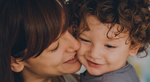 Photo of young mother's face close to her toddler's face