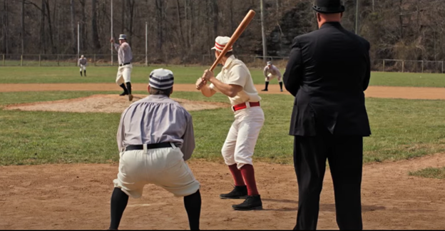    vintage photo of a batter and catcher and an umpire from behind the plate