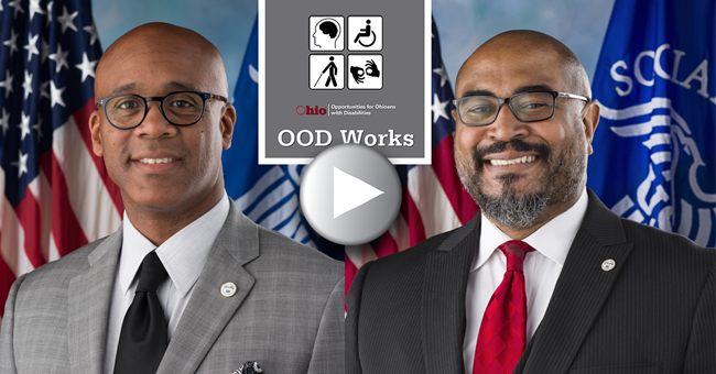 Two men both wearing glasses and suits. OOD Works and universal disability signs