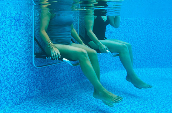 EdgeMate Pool Chairs in a pool with two women sitting on them