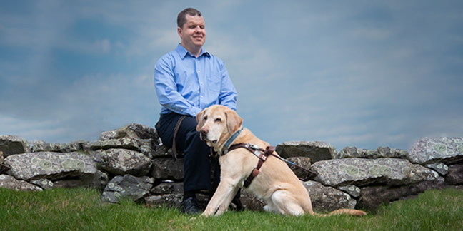 All About Accessibility, blind man with golden retriever dog on cloudy day near body of water