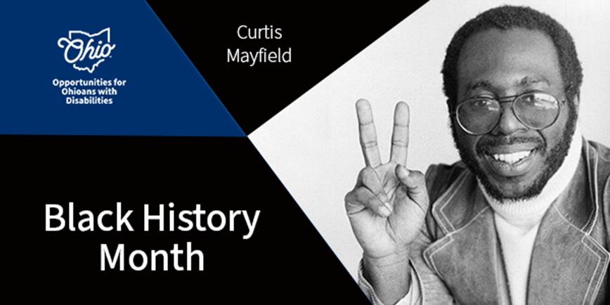 Curtis Mayfield smiling and making a peace sign with his hand at the camera.