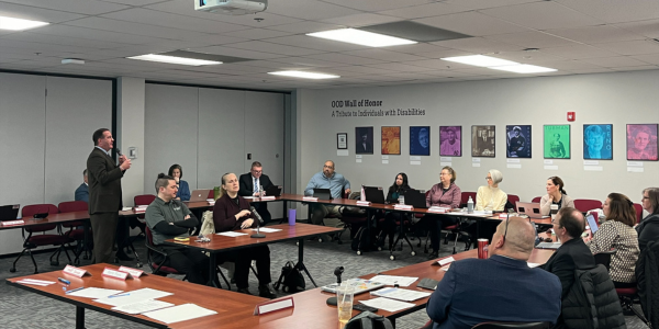 Director Miller stands with a microphone talking to the OOD Council members and guests during the January OOD Council meeting.