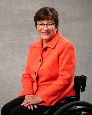 Headshot (smiling in wheelchair) Opening Keynote Presenter, Rosemarie Rossetti, Ph.D.  “Why Accessibility Matters”