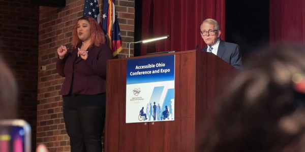 Governor Mike DeWine addresses attendees of the Accessible Ohio Conference & Expo with Marlena Schmitz, American Sign Language Interpreter.