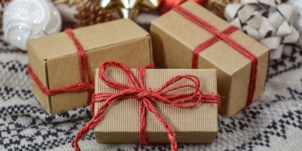 Three brown packages with red string tied around them.