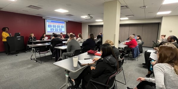 People seated during The Apprenticeship Information Session for employers in Toledo.