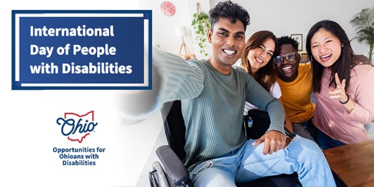 International Day of People with Disabilities and a group of four individuals smiling.