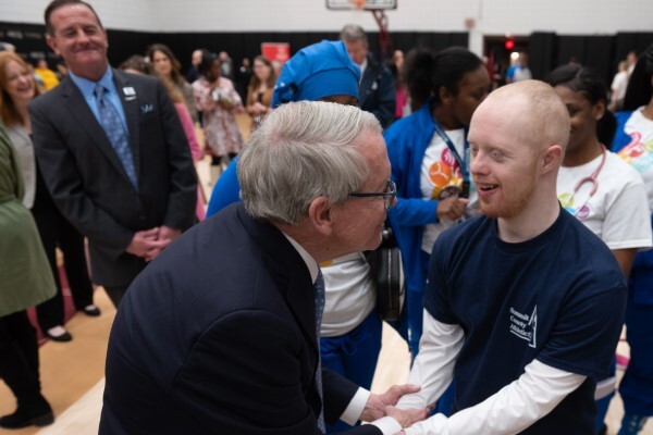 Governor DeWine meets with Summit County Special Olympics athlete, P.J. O’Neil, while OOD Director Kevin L. Miller watches.