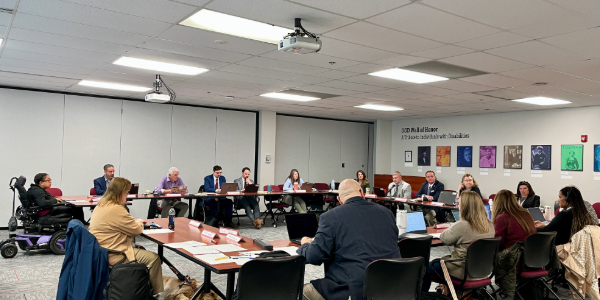 OOD Council members sit around tables in a square formation.
