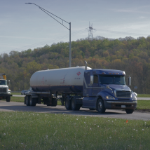 A semi truck on a highway off-ramp