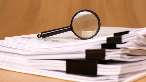 Magnifying glass with paperwork