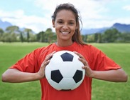 Female athlete holding soccer ball