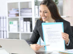 female smiling at laptop
